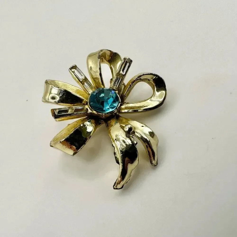 Coro vintage gold tone and blue rhinestone bow brooch